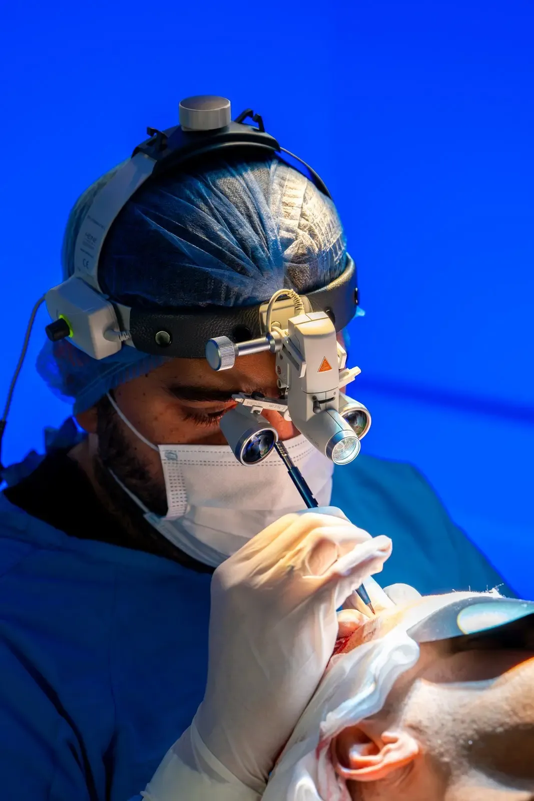 Vera Clinic surgeon working with magnification loupes